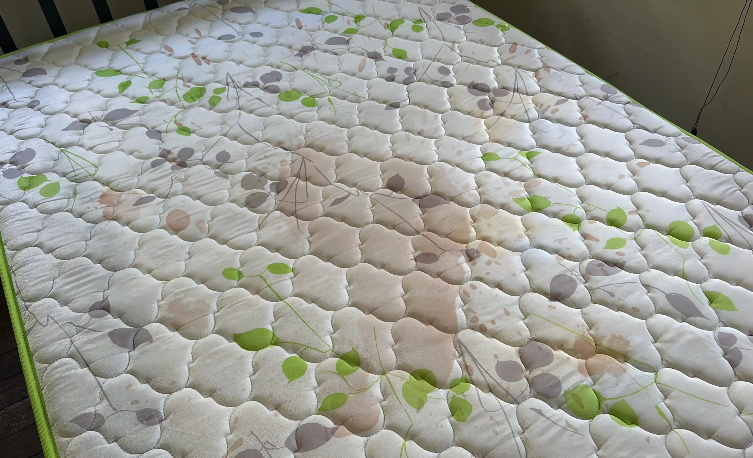 Mattress with visible stains before professional mattress cleaning